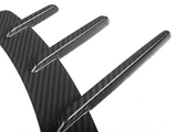 Three elongated, carbon fiber fins extending from a curved base, creating a sleek and modern pattern on a white background.