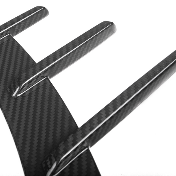 Three elongated, carbon fiber fins extending from a curved base, creating a sleek and modern pattern on a white background.