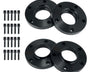 Four black wheel spacers with circular holes are laid out on a white surface, accompanied by sixteen matching screws arranged in two vertical rows.