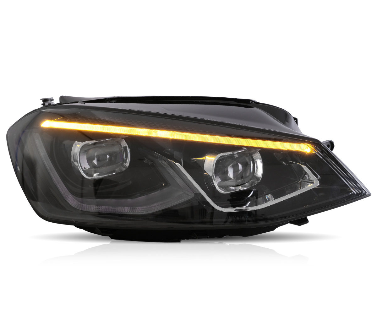A sleek car headlight with dual LED projectors and an amber LED strip is illuminated against a plain white background, highlighting its modern design.