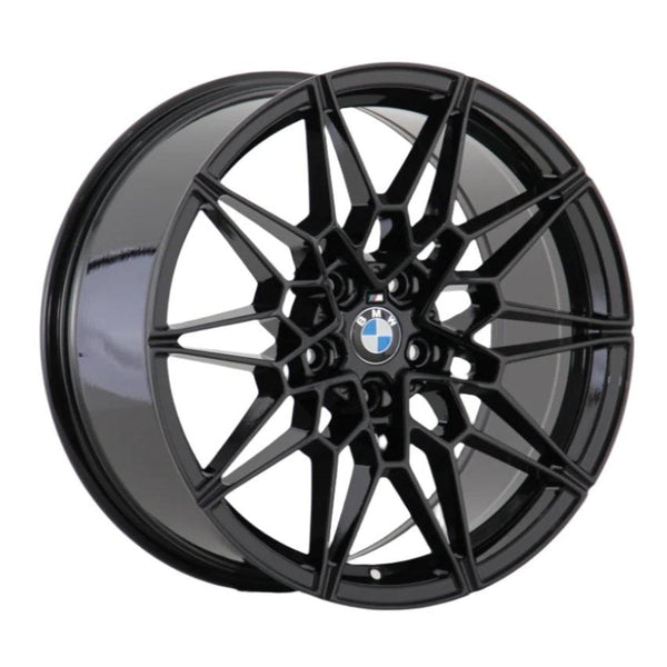 A black alloy wheel features a complex, geometric spoke design centered by a BMW logo, displayed against a plain white background.