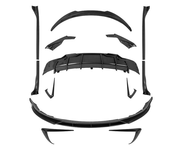 Carbon fiber car body kit parts, precisely arranged, suggesting assembly. Components include a diffuser, spoilers, side skirts, and splitters, placed on a plain white background.