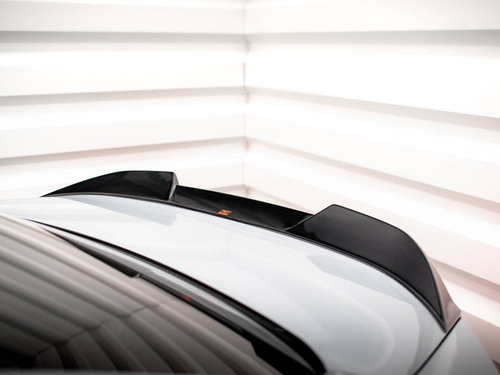 A car roof with a black spoiler sits stationary, surrounded by a white, segmented background, creating a modern, sleek atmosphere.