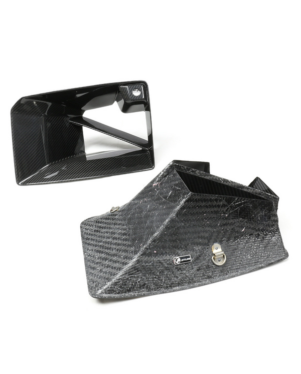 Carbon fiber intake ducts rest on a white surface, one upright and one on its side. A small silver logo reads "JETLINE" on the larger duct.