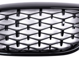 Honeycomb-patterned black grille in a car front view, with a glossy finish. The grille has a three-dimensional design, appearing against a bright, neutral background. No text is present.