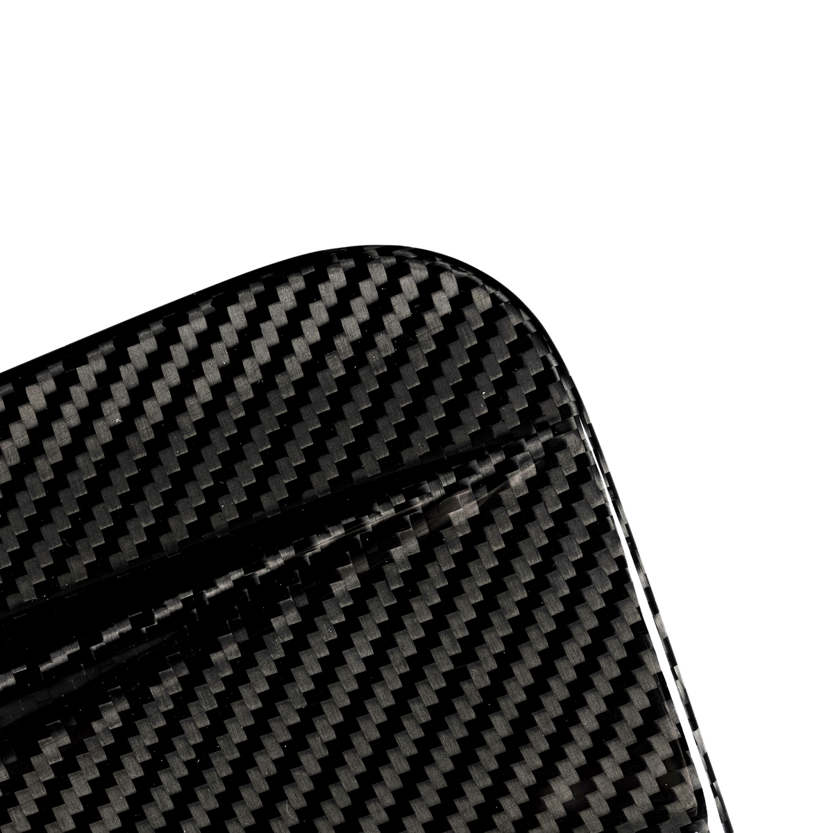 A close-up of a carbon fiber object with a visible textured pattern, featuring a rounded corner, set against a plain white background.