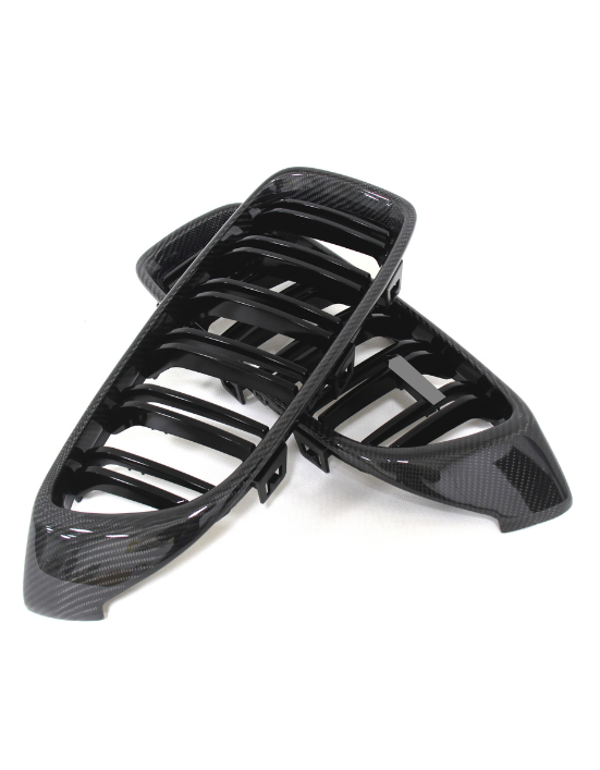 Two black car grilles with a glossy carbon fiber finish are stacked on a white background, showcasing a sleek, modern design with multiple horizontal slats.