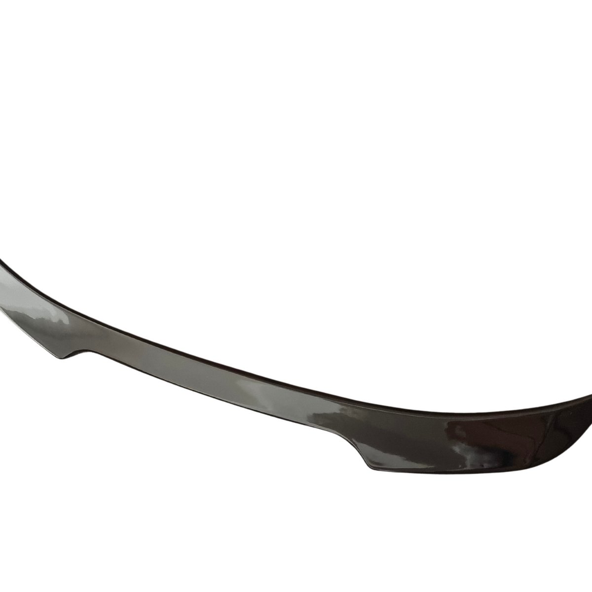A sleek car spoiler, curved upward at the ends, appears against a plain white background, highlighting its aerodynamic design.
