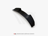 A black car spoiler, featuring aerodynamic contours, sits isolated on a white background. Text below reads: 