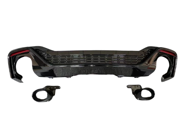 A glossy black car bumper with honeycomb grille design is displayed against a white background, accompanied by two matching circular pieces positioned below it.