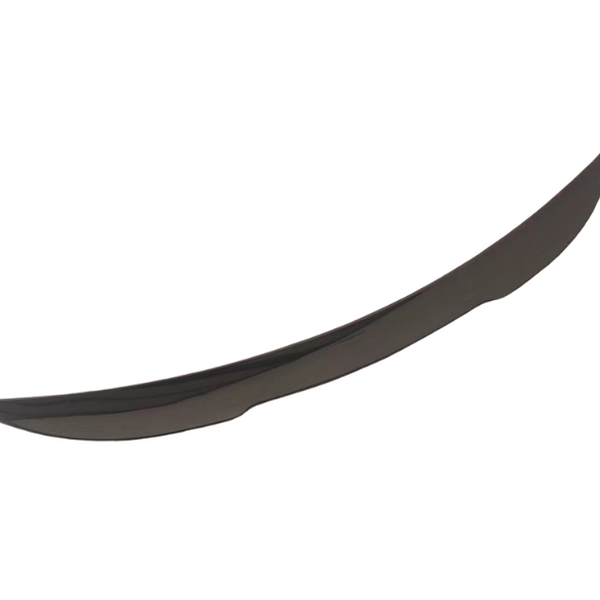 A black carbon fiber car spoiler, curved and aerodynamic, is isolated against a white background, highlighting its sleek design and subtle sheen.