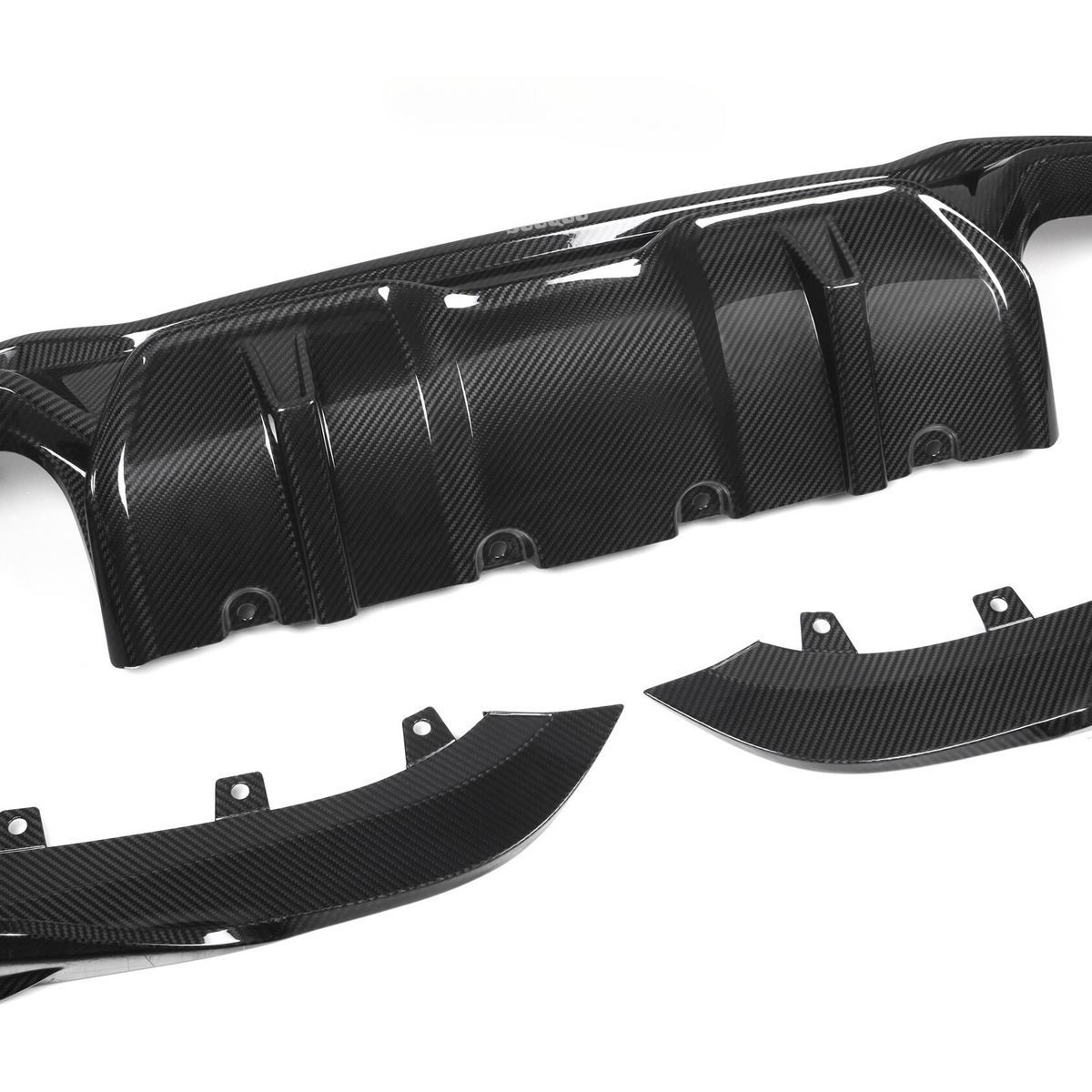 A glossy black carbon fiber car diffuser rests on a plain white background, consisting of one large central piece and two smaller side components with visible bolt holes.