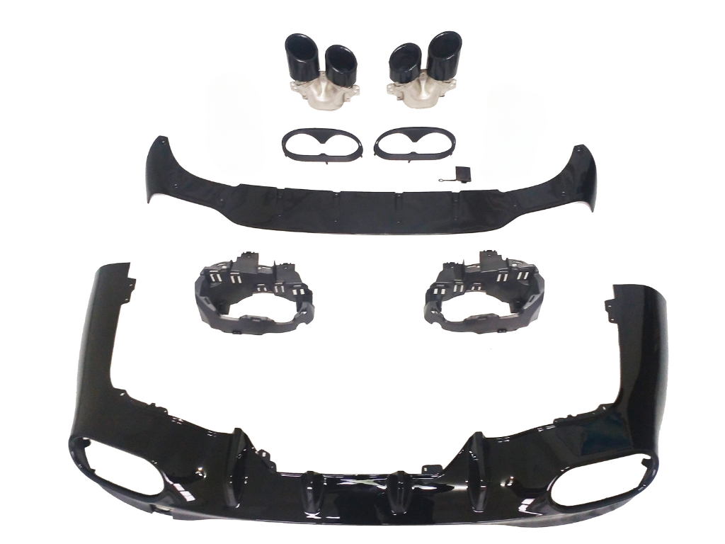 Car bumper components laid out, showcasing black aerodynamic parts, dual exhaust tips, and mounting brackets on a white background, arranged for assembly display.