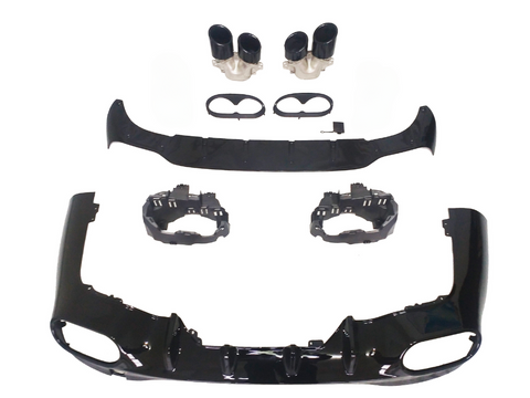 Car bumper components laid out, showcasing black aerodynamic parts, dual exhaust tips, and mounting brackets on a white background, arranged for assembly display.