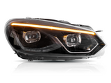A car headlight emits an orange light strip, featuring black housing and clear lenses, set against a plain white background.