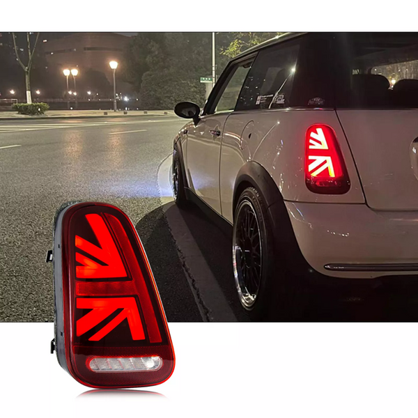 A car features distinctive red taillights resembling a national flag at night on a city street. A close-up inset of the taillight design is displayed in the foreground.