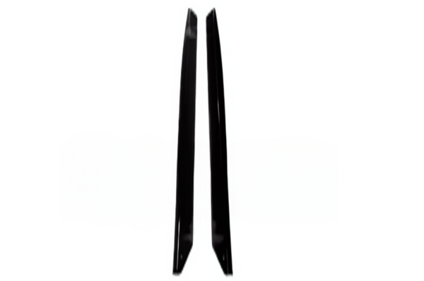 Two black objects, possibly blades or panel pieces, stand upright in parallel, facing inward against a plain white background.