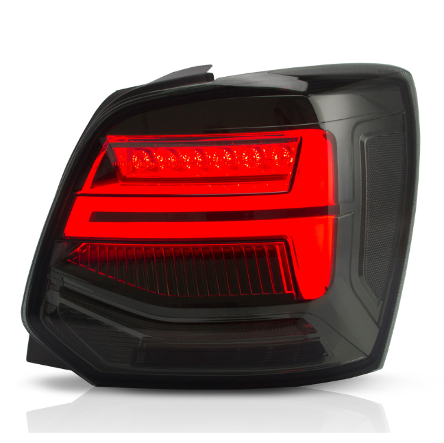 A modern, black car taillight illuminated with bright red LED strips, set against a plain white background, highlighting sleek design elements and reflective surfaces.