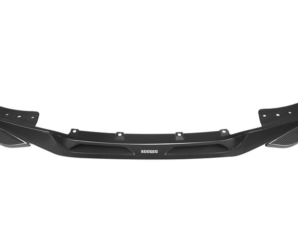A black carbon fiber car front splitter features aerodynamic lines and mounting holes. The text "SOOQOO" is printed in white at the center. Predominantly displayed against a white background.