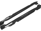 Two elongated, curved carbon-fiber automotive side skirts with mounting holes are laid side by side against a plain white background.