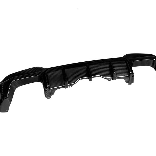 A carbon fiber rear diffuser with fins, designed for aerodynamics, rests on a white background. The set includes side panels detached from the main diffuser piece.