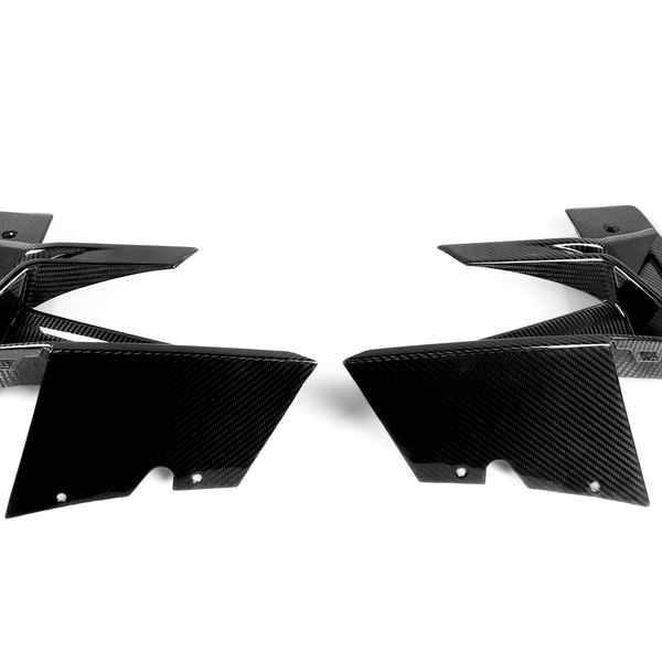 Two black carbon fiber car parts face each other, showcasing sleek, angular designs on a plain white background.