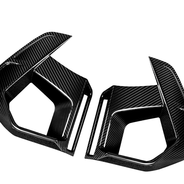 Two angular, carbon fiber car air vents, placed opposite each other, against a plain white background; their sleek, textured surfaces highlighting a modern, aerodynamic design.
