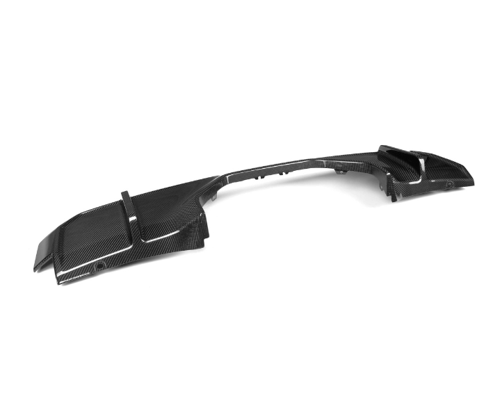 A sleek, black carbon fiber car bumper sits on a plain white background, showcasing its aerodynamic design with angular edges and subtle ridges.