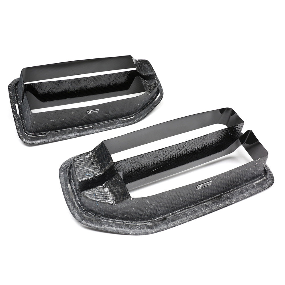 Two rectangular black vent grilles feature parallel slats, set against a white background. Their surfaces have a textured, carbon fiber-like pattern, and a logo reads "APR Performance."