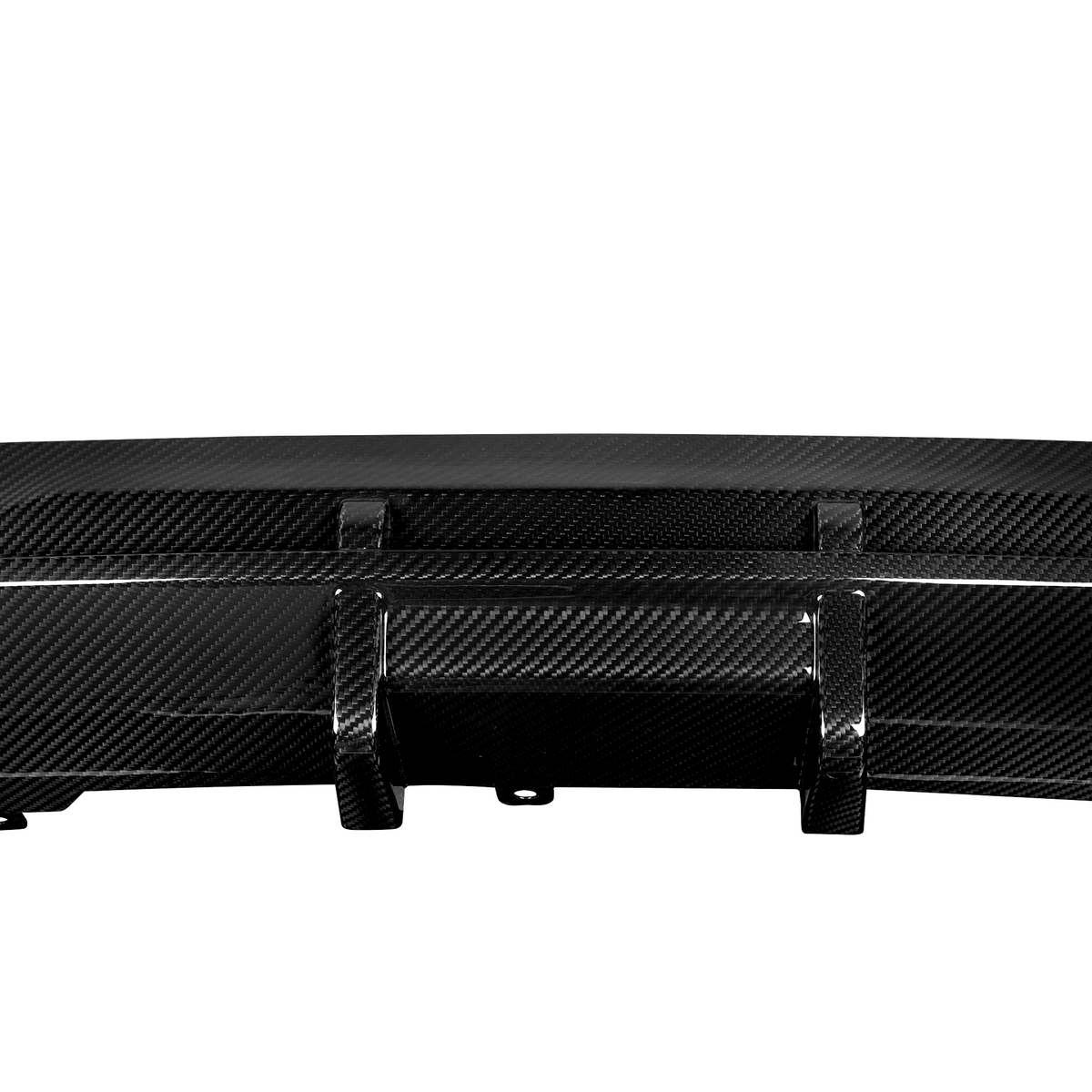 A black carbon fiber car diffuser, featuring multiple vertical fins, sits isolated against a plain white background, emphasizing its sleek, aerodynamic design.