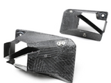 Carbon fiber ducts with a textured pattern are positioned against a plain white background. One duct displays a 