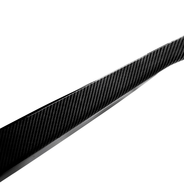 A sleek, tapered piece of carbon fiber rests against a plain white background, showcasing its woven texture and glossy finish.