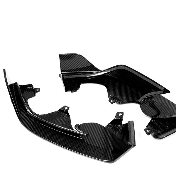 Carbon fiber automotive parts are arranged on a white background, displaying their shiny, textured surface and intricate design.