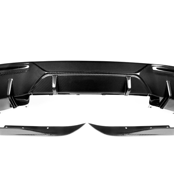 A carbon fiber car rear diffuser with aerodynamic fins is positioned against a plain white background, highlighting its sleek, black contoured surface and modern design elements.