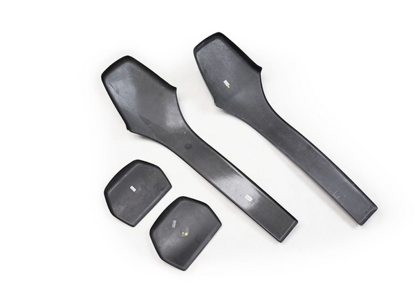Black, flat plastic handles and pads lie on a plain white background, arranged neatly in a set of two long and two small pieces.