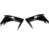 Two carbon-fiber air vents, placed symmetrically, have angular, aerodynamic fins against a plain white background.