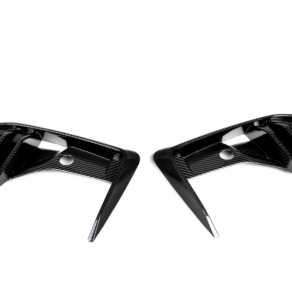 Two carbon-fiber air vents, placed symmetrically, have angular, aerodynamic fins against a plain white background.