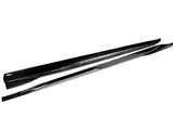 Two sleek, black carbon-fiber side skirts lie parallel on a white background, showcasing their smooth, aerodynamic design ideal for automotive enhancements.