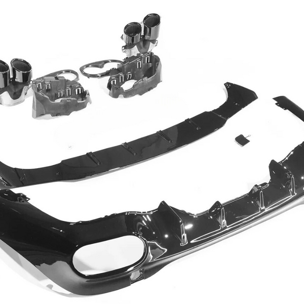 Car bumper parts are laid out, including a black bumper with cutouts, two cylindrical exhaust tips, and a splitter, on a white background, ready for assembly or display.