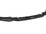 A black carbon fiber car bumper is shown with aerodynamic design elements, featuring the text 