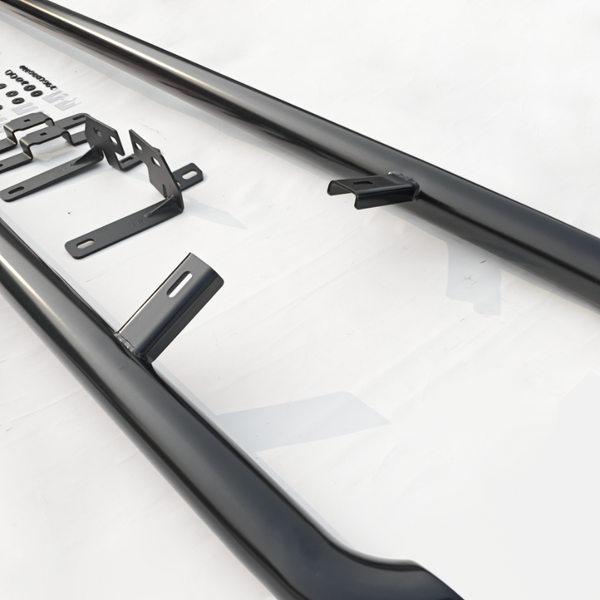 Black metal bars and brackets arranged on a white surface, with screws and washers nearby, suggesting an assembly of some kind.