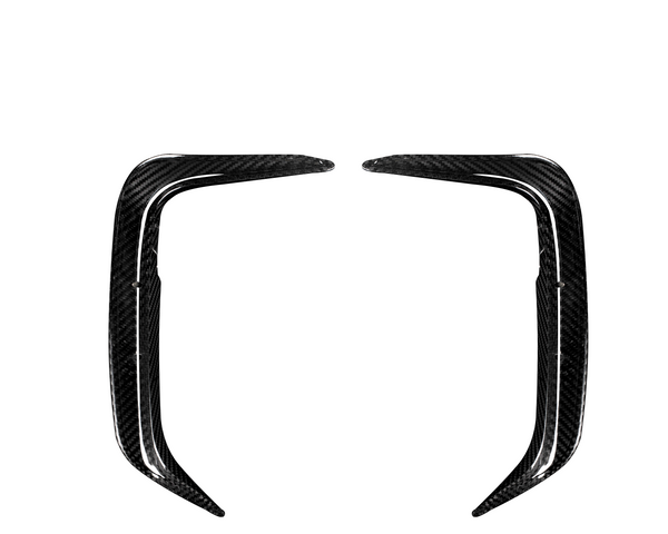 Two elongated, curved carbon fiber components face each other symmetrically on a plain white background, resembling aerodynamic car parts or trim pieces.