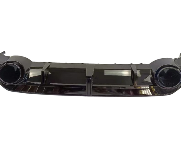 A dark-colored car bumper features two circular fog light housings and multiple vertical vents, set against a plain white background, highlighting its sleek and modern design.