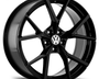 A black alloy wheel with a glossy finish prominently displays the Volkswagen logo at its center; it has five large, split spokes, viewed against a plain white background.