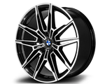 A black and silver alloy wheel features a sleek, angular spoke design with a prominent blue and white circular logo at the center, displayed against a white background.