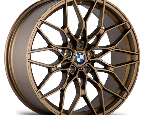 A bronze alloy wheel with intricate, multi-spoke design featuring a BMW logo at the center, displayed against a plain white background.