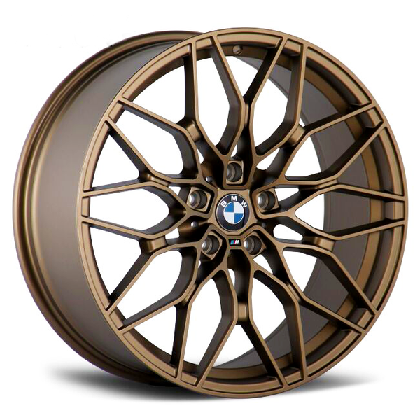 A bronze alloy wheel with intricate, multi-spoke design features a central emblem displaying "BMW." It rests on a white background, emphasizing its elegant and complex structure.