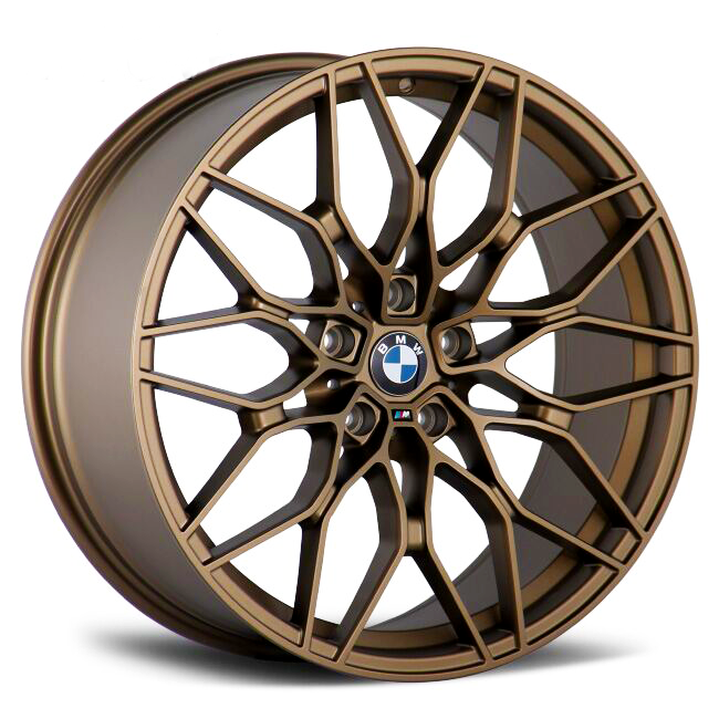 Bronze alloy wheel featuring a starburst pattern and BMW emblem at center, displayed on a white background.