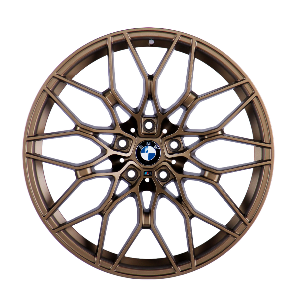 Bronze car wheel with intricate, multi-spoke design, centered on a logo featuring black, white, and blue colors, resting against a plain white background.