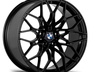 A black, multi-spoke alloy wheel with the BMW logo at the center, displayed against a white background.